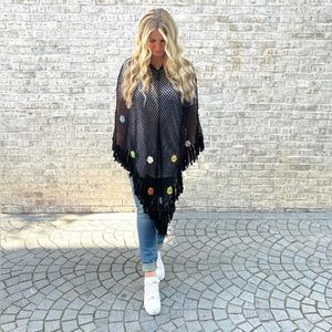 Crocheted black poncho with flower details